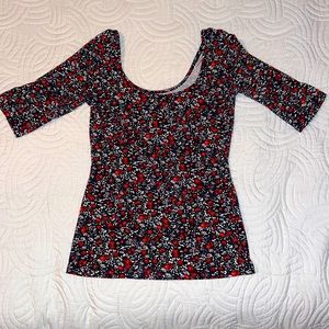 I am selling a half sleeve shirt with pretty red, blue, and white flowers!